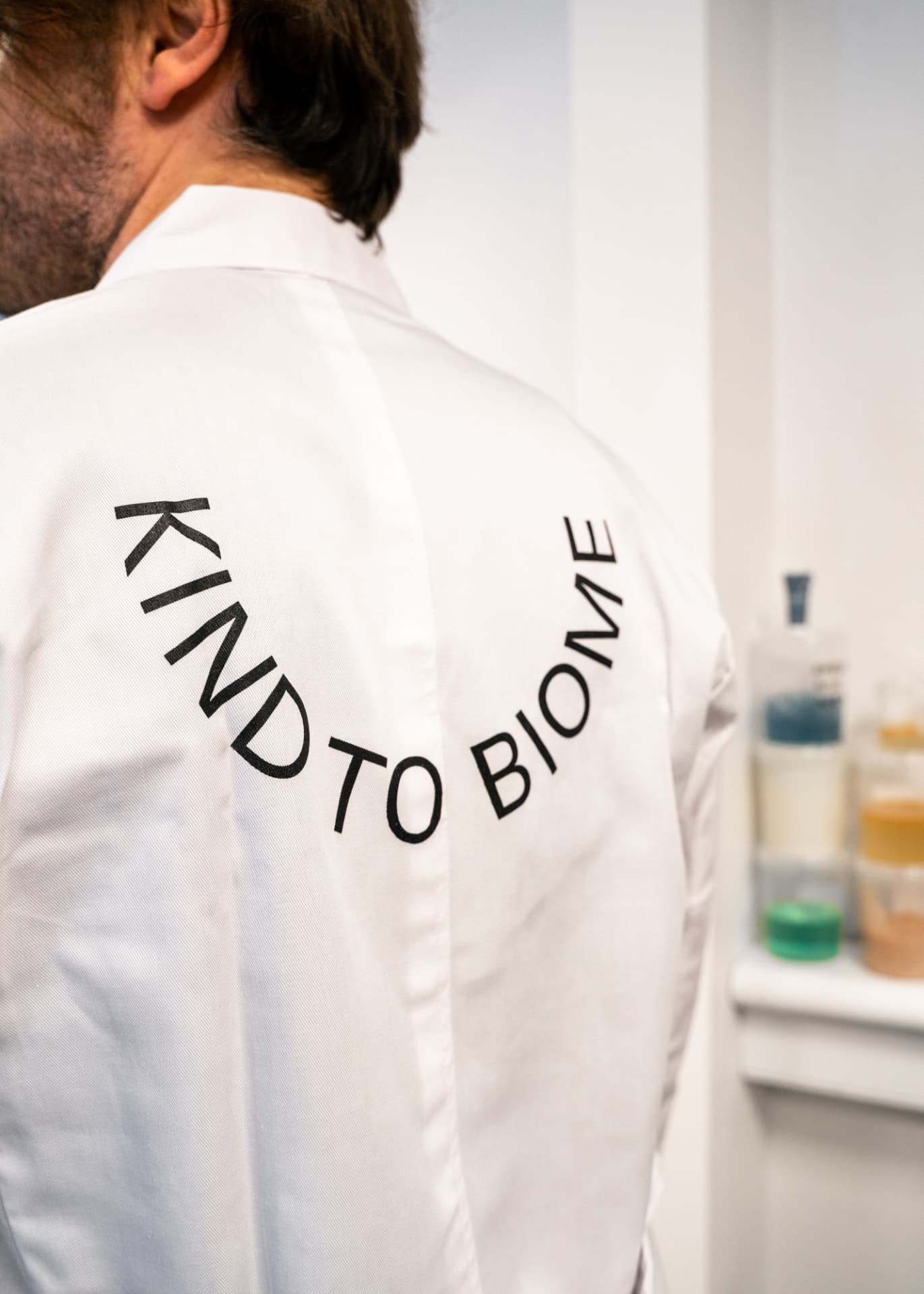 Scientist wearing a KIND TO BIOME lab coat in the laboratory
